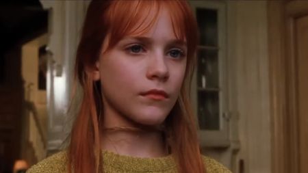 Evan Rachel Wood looking out the window in Practical Magic. 