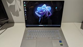 A silver HP Envy 16 laptop sitting on a table