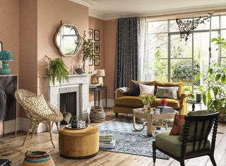 traditional living room with pink walls and boho decor