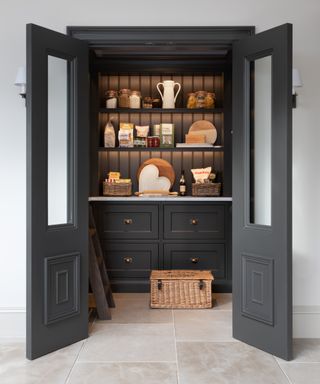 Walk-in pantry ideas with black interior and shelf lighting