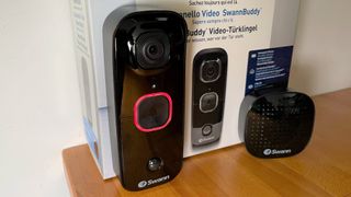 SwannBuddy Video Doorbell review: close up of camera lens up aaginst product box