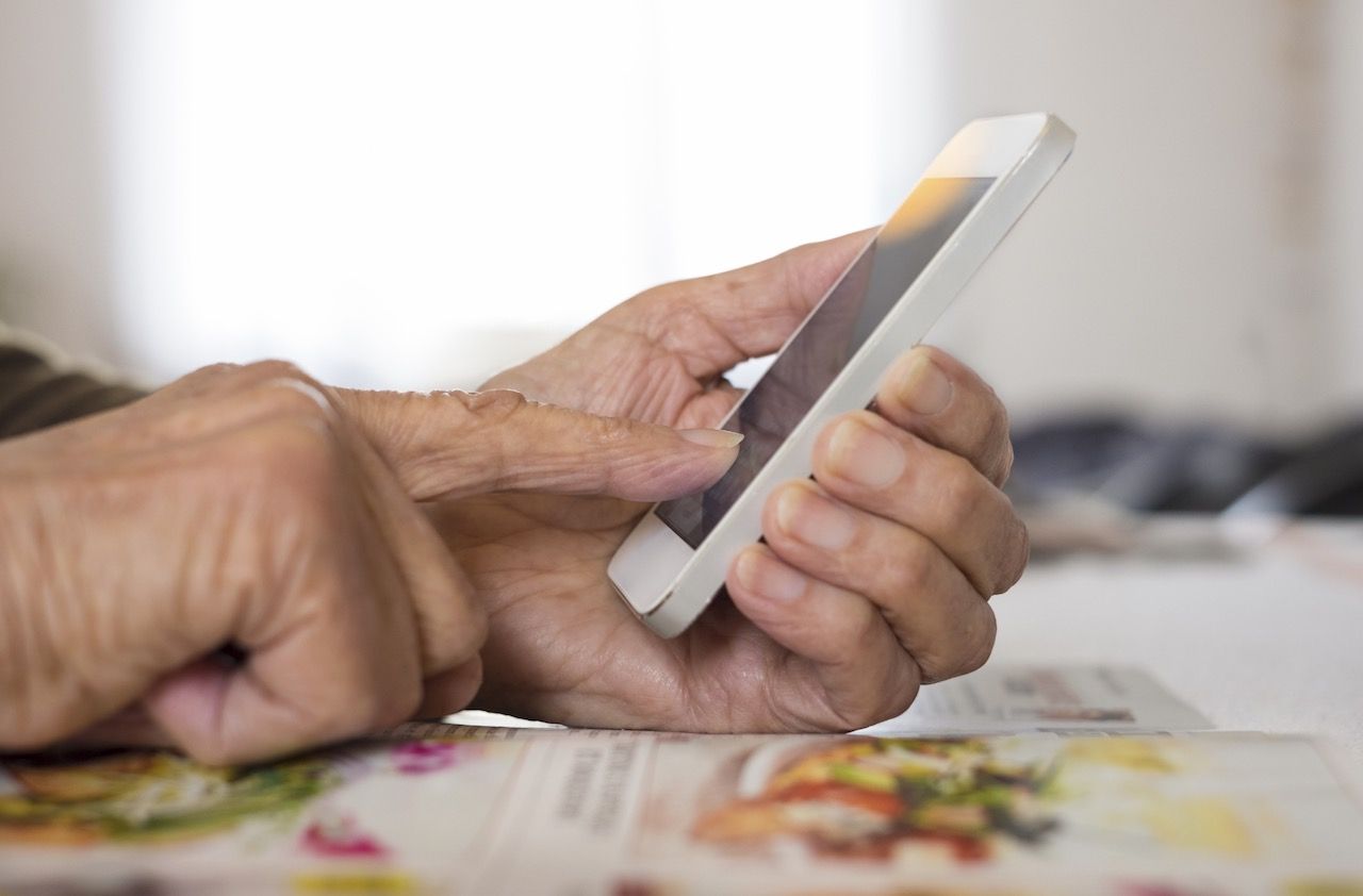 Senior woman Using mobile phone at home