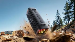 A render showing the Soundcore Boom 3i Bluetooth speaker above sandy, rocky ground. It appears to be exploding from the ground into the air, which Bluetooth speakers don't usually do