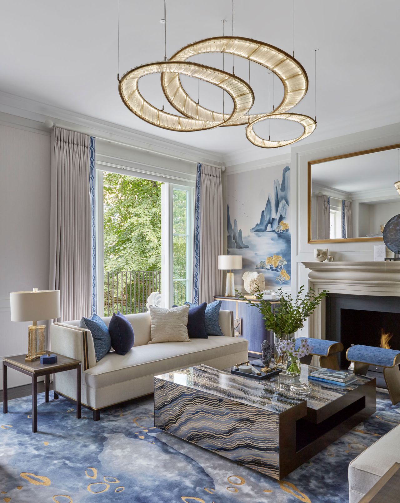 Stone-esque blue and white design rug, coffee table and wallpaper with hints of orange,