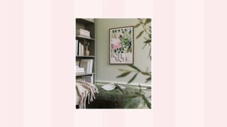 A picture of a green living room with wall art on a pink and white background