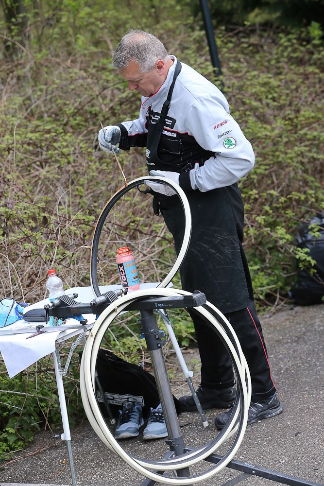 A mechanic glues tyres in preparation for the Giro.