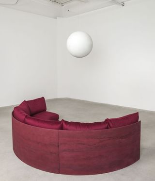 seating area with maroon sofa