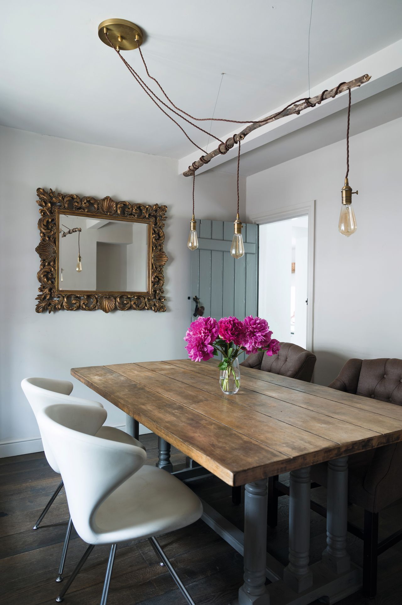 cottage dining room with reclaimed lighting above