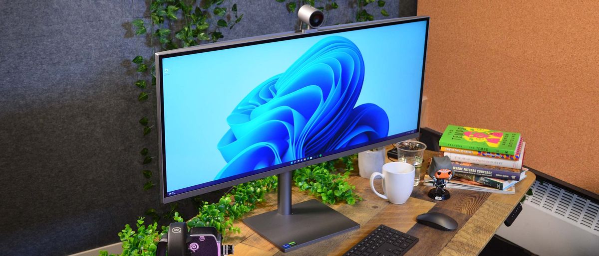 An HP Envy 34 on a desk in front of a plant