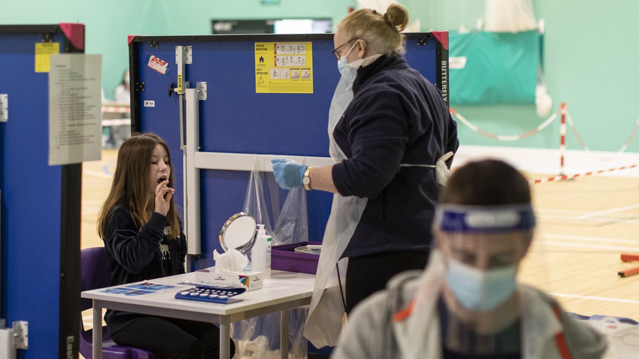 A pupil uses a lateral flow test on her return to school today