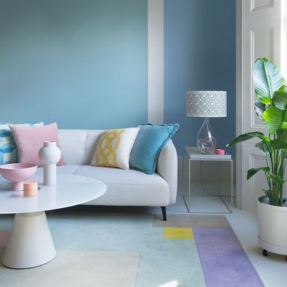 Blue wall with sofa and lamp