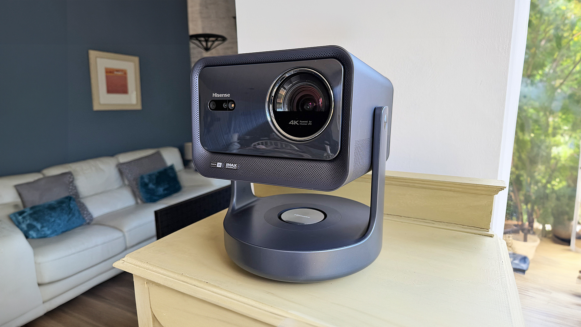 Hisense C2 Ultra home cinema projector on wooden shelf in living room