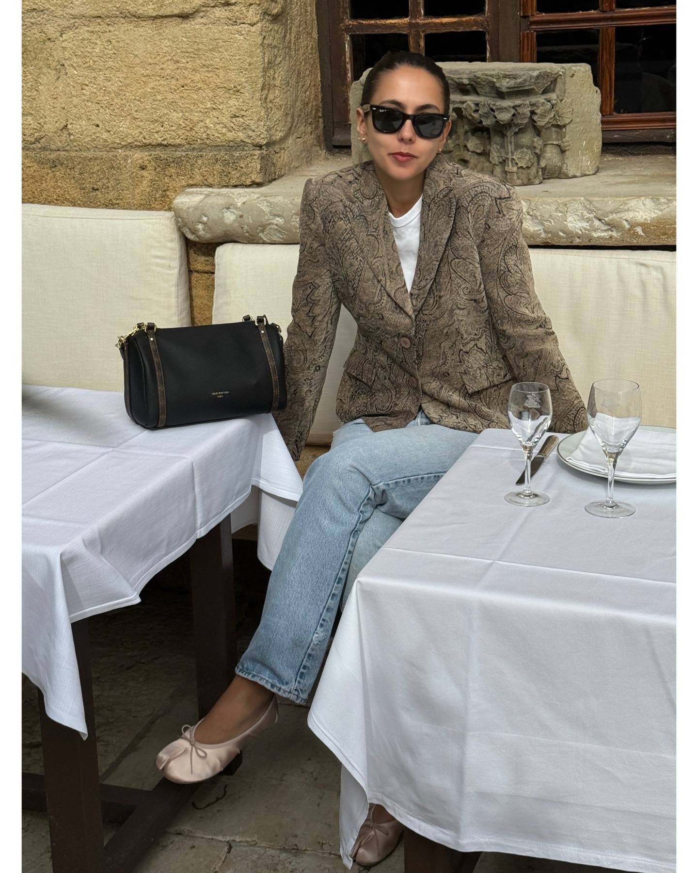 Hanna Marzouki Widlund wearing jeans with a printed blazer and Maison Margiela satin ballet flats.