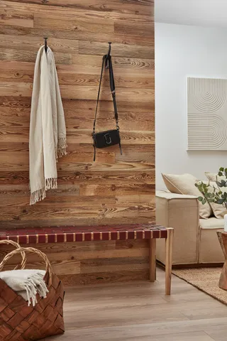 A warm and inviting hallway using reclaimed wooden boards as panelling