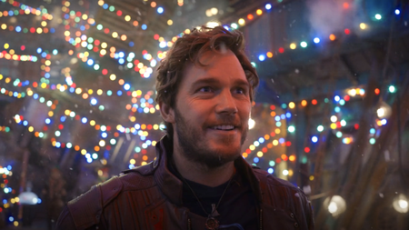 Chris Pratt as Peter Quill smiling with lights in the background in Guardians of the Galaxy holiday special 