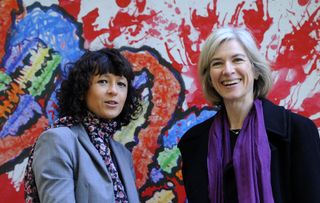 Emmanuelle Charpentier and Jennifer Doudna posse beside a painting made by children of the genoma at the San Francisco park