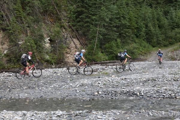 Riders navigate their way along the riverbed