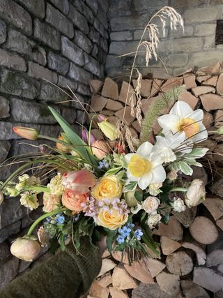 Spring flower arrangement with ranunculus, tulips and roses