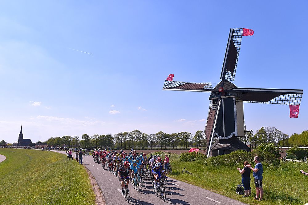 The peloton passes one of many windmills
