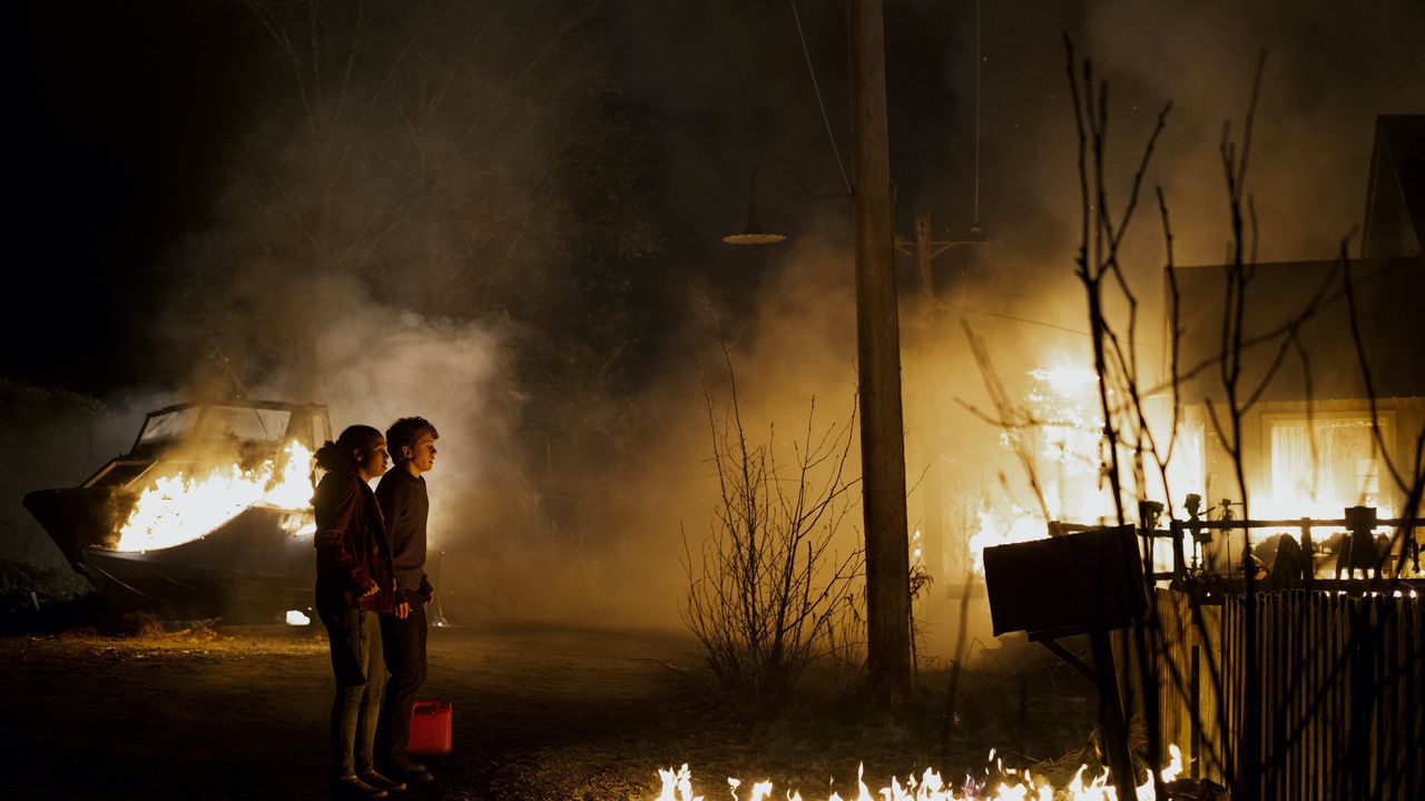 Young girl and boy watching fire