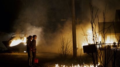 Young girl and boy watching fire