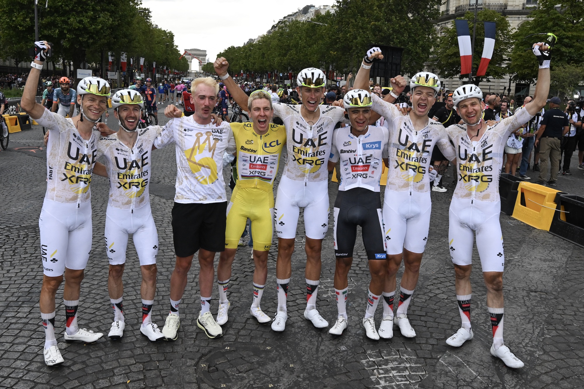 Tadej Pogačar celebrates his overall victory with UAE Team Emirates-XRG teammates after stage 21, including Brandon McNulty who stayed in France after abandoning on stage 18