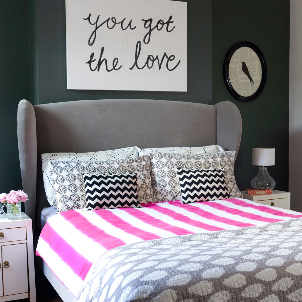 modern bedroom with grey headboard and personalised wall art