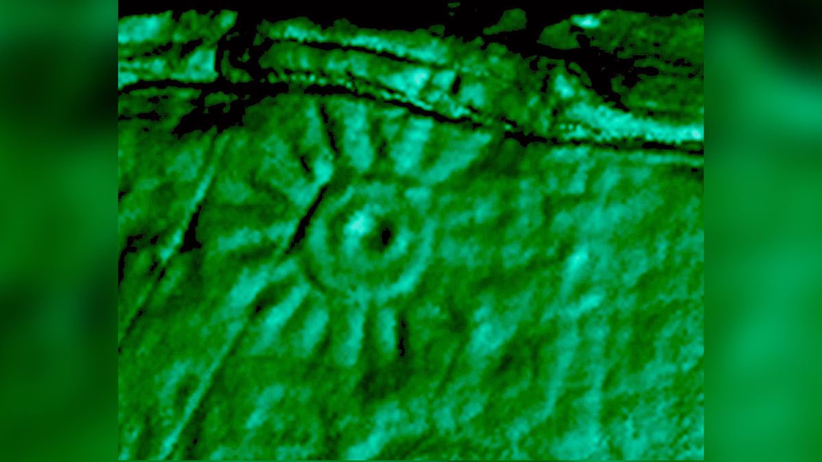 This image shows a close-up of one of the engravings on the monolith that was scanned and shown here in green contrast. The engraving appears circular with a hole in the center and lines radiating from the circle.