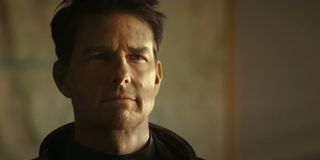Top Gun: Maverick Tom Cruise stands in his space suit