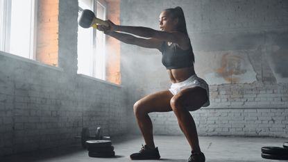 Woman performing kettlebell swings