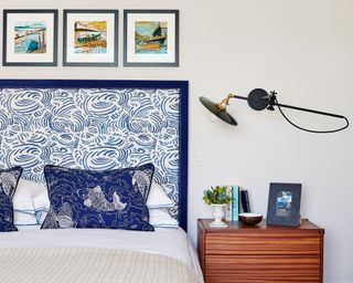 blue headboard and pillows with artwork
