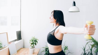 Woman doing standing dumbbell flys