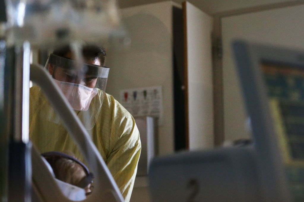 Hospital worker administers vaccine.