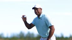 Tiger Woods holds his ball up to the crowd in appreciation at the 2023 Hero World Challenge