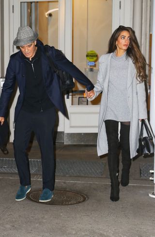 Amal Clooney wears a gray mini dress with thigh-high boots