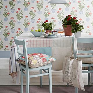 room with floral printed wall and dining table with chairs