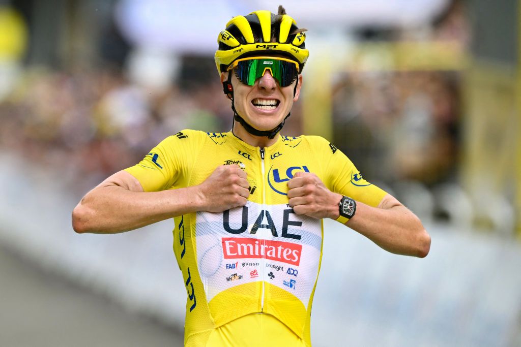 UAE Team Emirates team's Slovenian rider Tadej Pogacar wearing the overall leader's yellow jersey cycles to the finish line to win the 14th stage of the 111th edition of the Tour de France cycling race, 151,9 km between Pau and Saint-Lary-Soulan Pla d'Adet, in the Pyrenees mountains in southwestern France, on July 13, 2024. (Photo by Marco BERTORELLO / AFP)