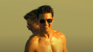 Tom Cruise shirtless playing football in Top Gun: Maverick