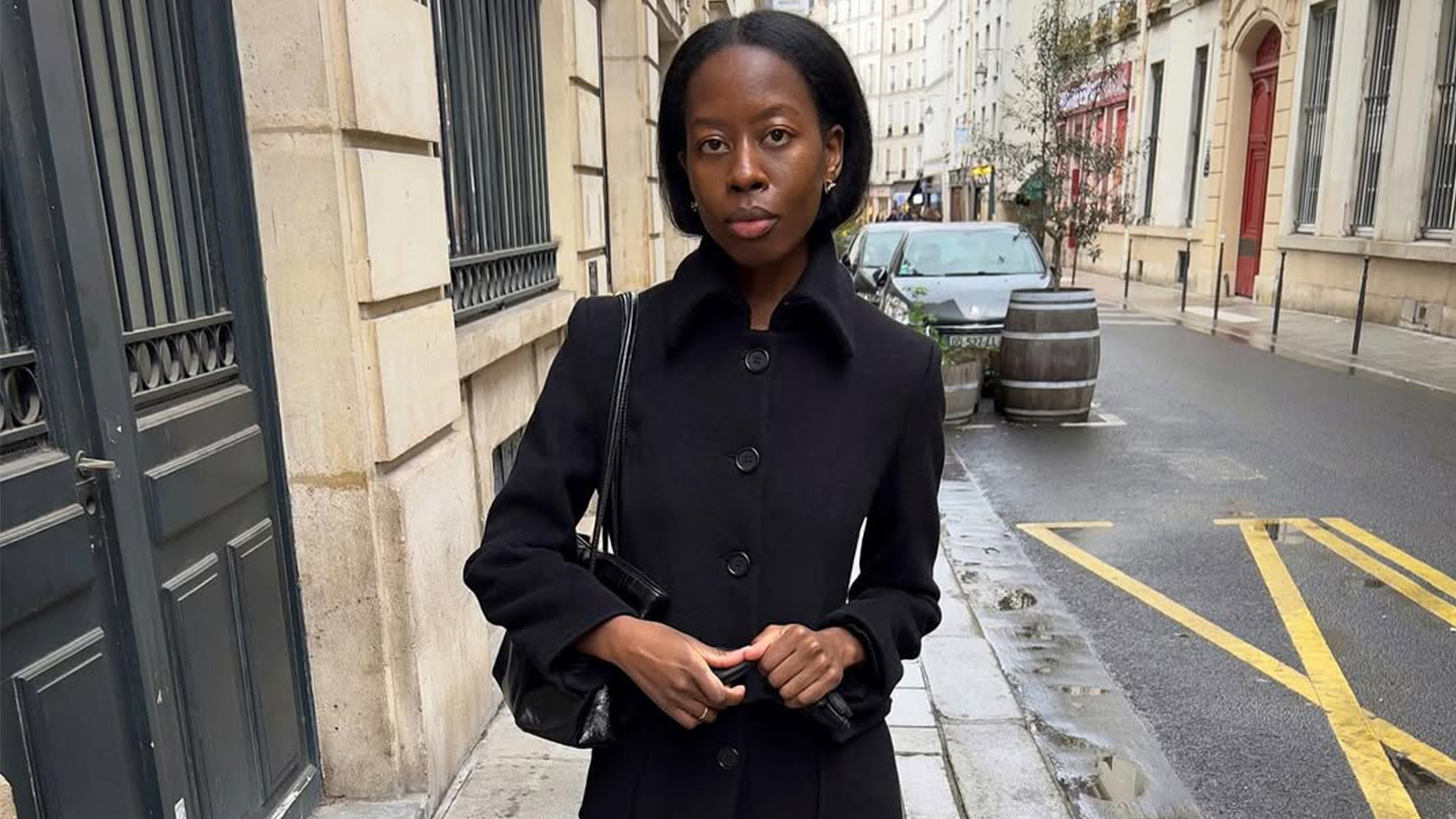 Sylvie Mus wearing a single-breasted trench coat.