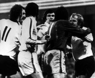 Norman Hunter and Derby's Francis Lee are separated by Leeds goalkeeper David Harvey (dark shirt) after they had exchanged blows