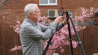 Man using a 3 Legged Thing Nicky, one of the best tripods