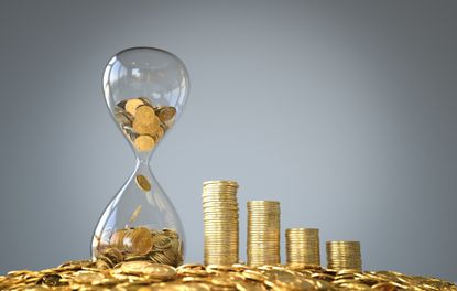 gold coins in an hourglass with stacks and piles of gold coins surrounding it