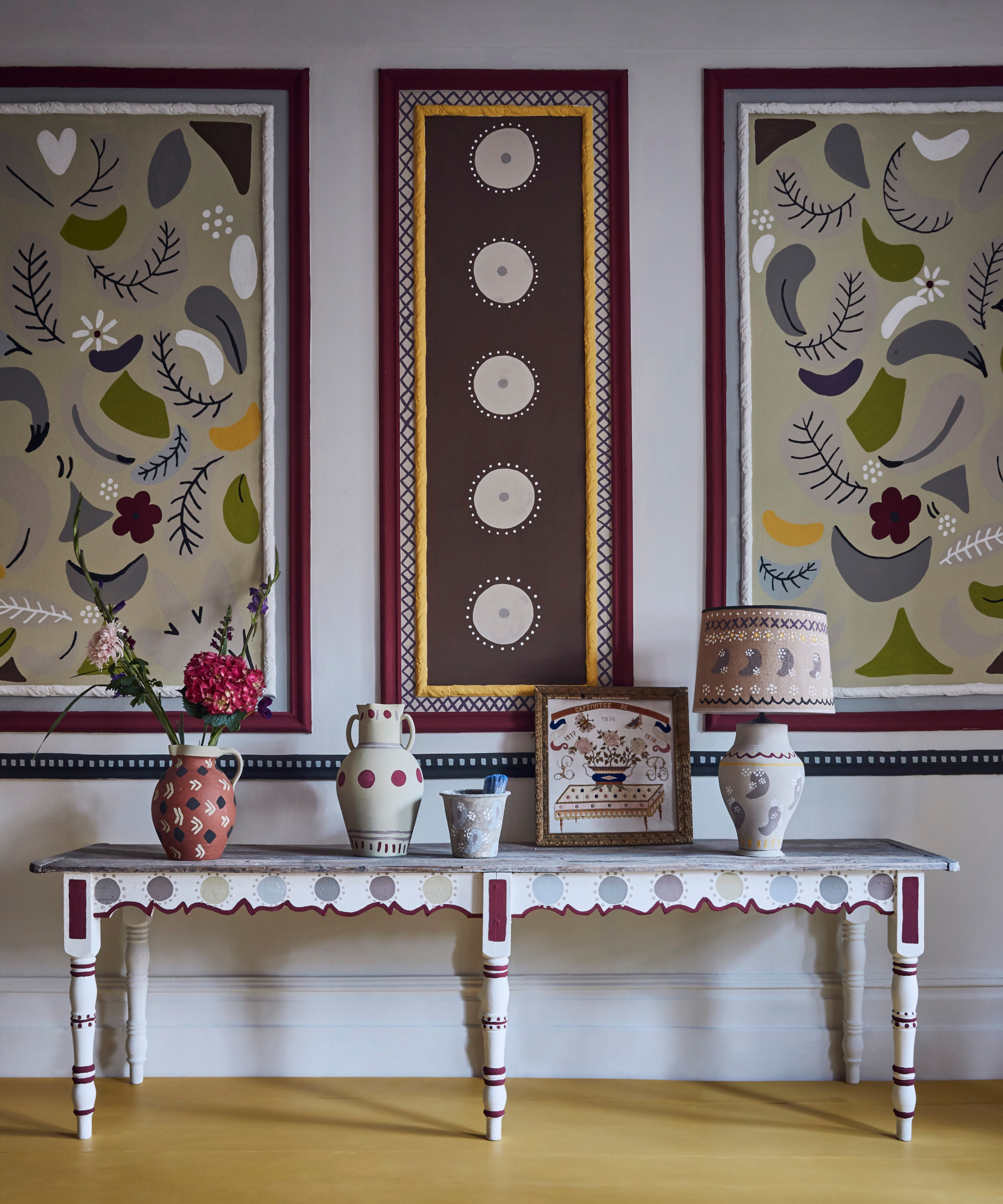 hallway with wall panelling with painted patterns inside panelling