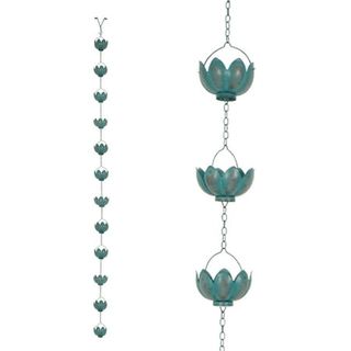 A worn patina effect rain chain with sculpted metal lotus flowers