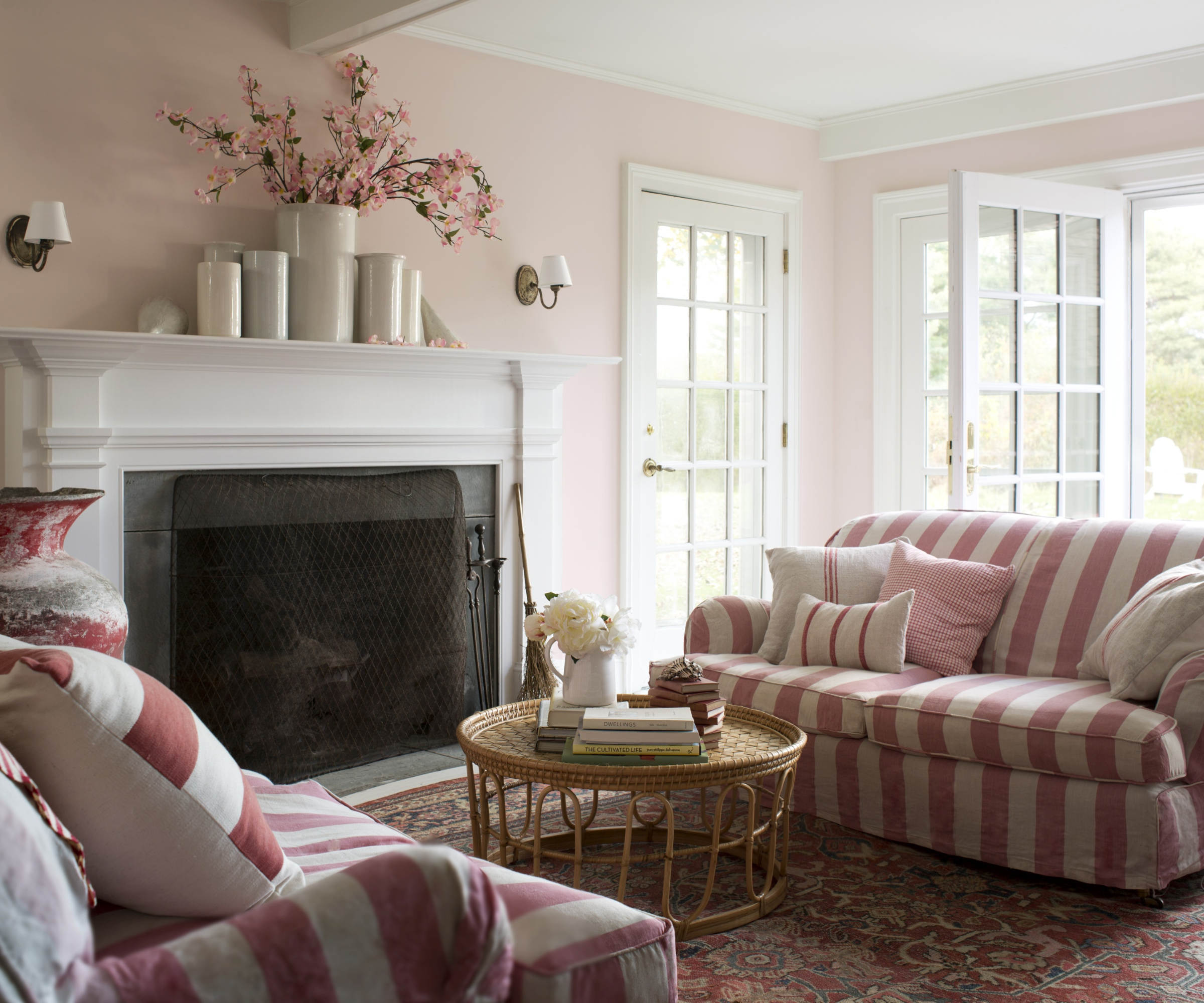 Living room with two pink stripe sofas opposite