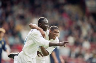 Tony Yeboah celebrates with Carlton Palmer after scoring for Leeds United against Wimbledon in September 1995.