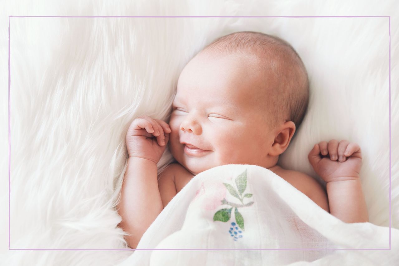 Baby under a soft blanket, smiling