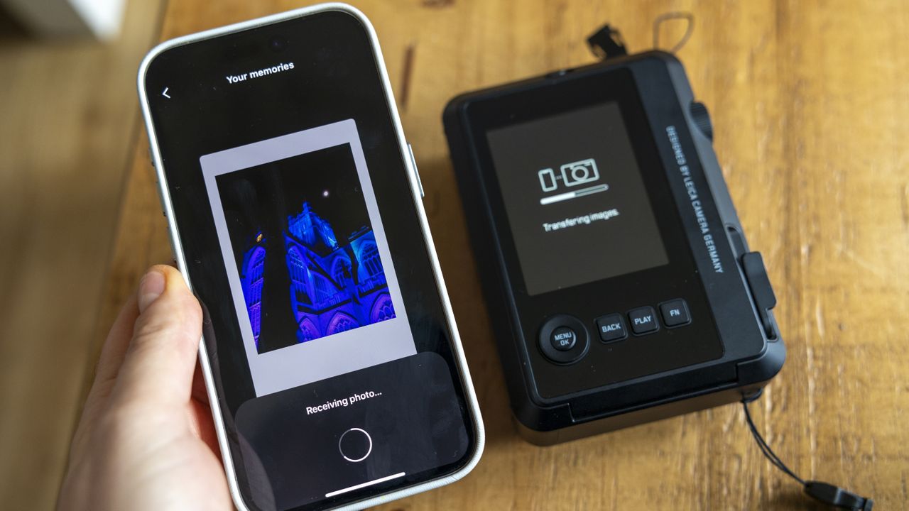 An iPhone 15 receiving photos from the Leica Sofort 2