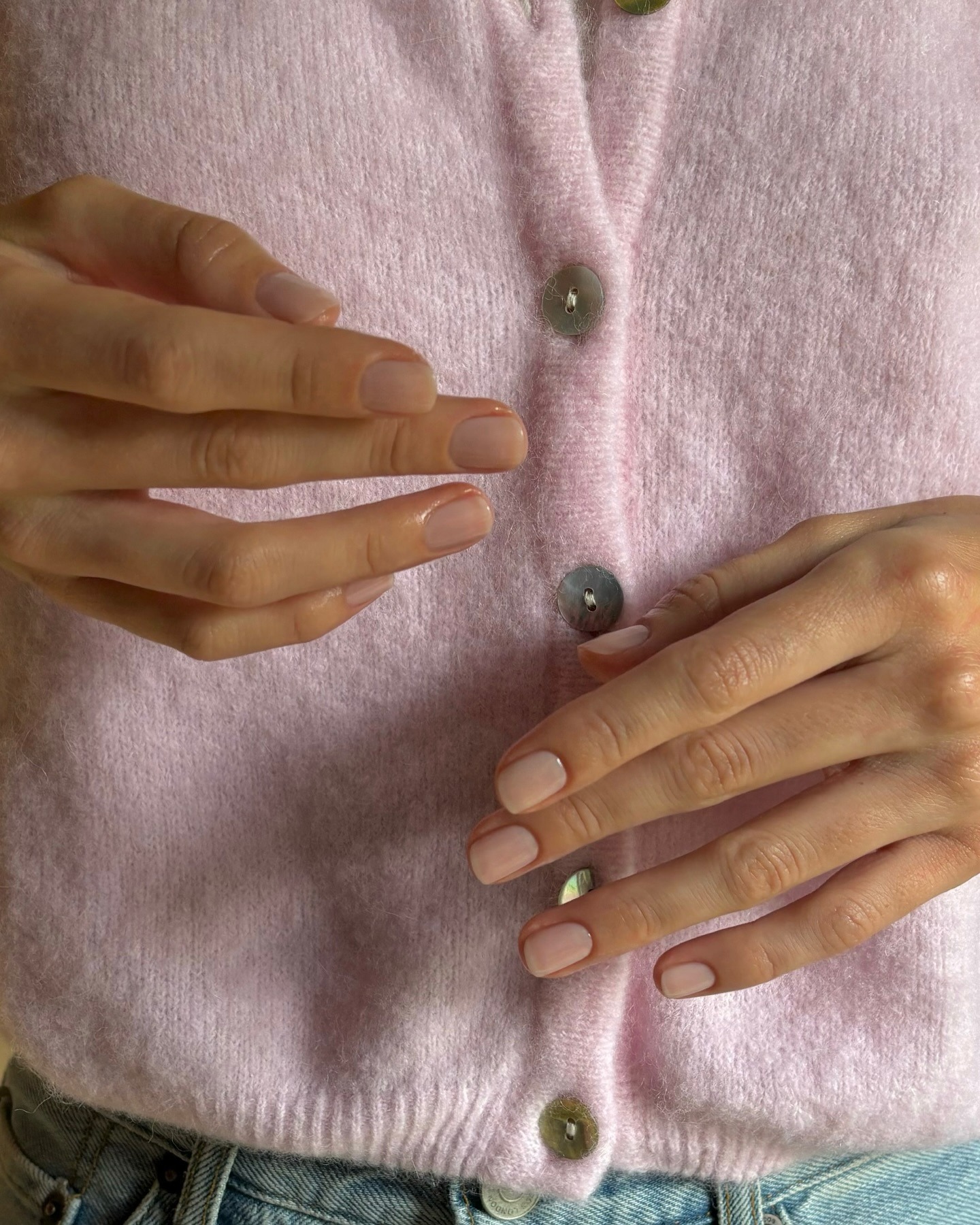 Pale pink nails.