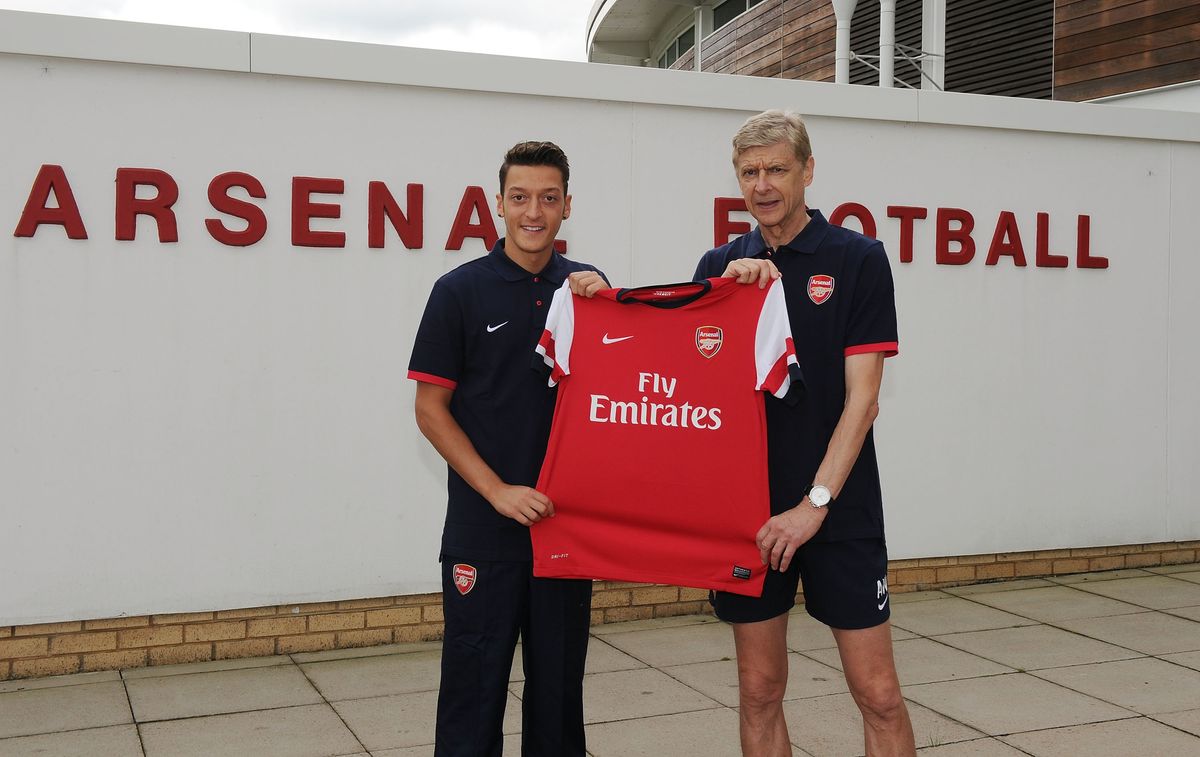 Arsenal manager Arsene Wenger with new signing Mesut Oezil at London Colney on September 12, 2013 in St Albans, England.